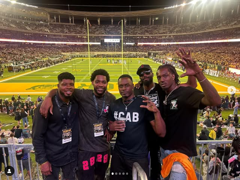 Ishmael Zamora and his Baylor teammates at a Baylor game during the Hall of Fame events, celebrating their reunion and the strong camaraderie they share, reflecting a family-like bond.